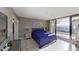 Bright bedroom with sliding doors to the balcony and tile floors, plenty of light throughout the space at 5611 Gulf Of Mexico Dr # 5, Longboat Key, FL 34228
