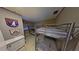 Shared bedroom featuring two sets of bunk beds, nautical decor, and a window at 5611 Gulf Of Mexico Dr # 5, Longboat Key, FL 34228