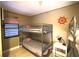 Bunk beds with silver frames, rope trim and a nautical steering wheel hanging on the wall at 5611 Gulf Of Mexico Dr # 5, Longboat Key, FL 34228