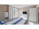 Bedroom with outdoor access, dresser, mirror and mounted tv at 5611 Gulf Of Mexico Dr # 5, Longboat Key, FL 34228