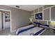 Bedroom featuring a washer/dryer closet and decorated accent wall at 5611 Gulf Of Mexico Dr # 5, Longboat Key, FL 34228