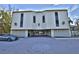 Exterior shot of building with covered parking and sleek architectural details at 5611 Gulf Of Mexico Dr # 5, Longboat Key, FL 34228