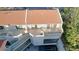 Elevated view of a multi-story home with tiled patios and a dark car at 5611 Gulf Of Mexico Dr # 5, Longboat Key, FL 34228