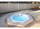 Outdoor hot tub on a brick patio surrounded by a white fence at 5611 Gulf Of Mexico Dr # 5, Longboat Key, FL 34228