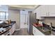 Bright kitchen with stone countertops, modern appliances, and wood-look flooring at 5611 Gulf Of Mexico Dr # 5, Longboat Key, FL 34228
