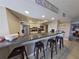 Kitchen bar featuring seating, granite countertops, white cabinets, and stainless steel appliances at 5611 Gulf Of Mexico Dr # 5, Longboat Key, FL 34228