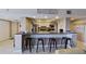 Kitchen bar featuring seating, granite countertops, white cabinets, and stainless steel appliances at 5611 Gulf Of Mexico Dr # 5, Longboat Key, FL 34228