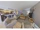 Bright living room with beach decor, tile floors, and access to kitchen area at 5611 Gulf Of Mexico Dr # 5, Longboat Key, FL 34228
