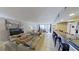 Comfortable living room with beach decor, tile floors, and sliding glass doors to the outside at 5611 Gulf Of Mexico Dr # 5, Longboat Key, FL 34228