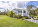 Inviting front porch featuring white railings and manicured landscaping at 6116 Verna Bethany Rd, Myakka City, FL 34251