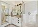 Bright bathroom featuring a white vanity, sink, and a tiled walk-in shower with glass door at 6512 Tailfeather Way, Bradenton, FL 34203