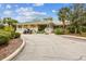 Beautiful clubhouse with a golf cart parked outside on a sunny day with lush landscaping at 6512 Tailfeather Way, Bradenton, FL 34203