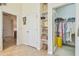 Hallway with an open closet with shelves, and doorways leading to other rooms at 6512 Tailfeather Way, Bradenton, FL 34203