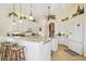 Spacious kitchen featuring white cabinetry, a breakfast bar, and modern appliances at 6512 Tailfeather Way, Bradenton, FL 34203