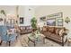 Comfortable living room featuring plush sofas, accent chairs, and decorative artwork on the walls at 6512 Tailfeather Way, Bradenton, FL 34203