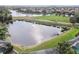 Scenic view overlooking a tranquil pond and lush green golf course in a desirable community at 6512 Tailfeather Way, Bradenton, FL 34203