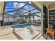 Screened in patio with pool, palm trees, and view of the backyard at 6512 Tailfeather Way, Bradenton, FL 34203