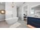 Luxurious bathroom with soaking tub, glass shower, and a view into the bedroom at 870 N Shore Dr, Anna Maria, FL 34216