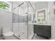 Elegant bathroom with a glass shower, modern vanity with an illuminated mirror, and a sleek design at 870 N Shore Dr, Anna Maria, FL 34216