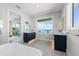 Bright bathroom featuring double vanities, and a large window with ocean views at 870 N Shore Dr, Anna Maria, FL 34216