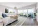 Spacious bedroom with water view, large windows, deck access, and stylish furnishings at 870 N Shore Dr, Anna Maria, FL 34216