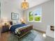 Cozy bedroom with a rattan bed frame, stylish rug, and plenty of natural light at 870 N Shore Dr, Anna Maria, FL 34216