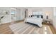 Bright bedroom with hardwood floors, sliding barn door to the bathroom, and chic coastal decor at 870 N Shore Dr, Anna Maria, FL 34216