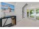 Bright foyer featuring tiled floors, stairs, and backyard views at 870 N Shore Dr, Anna Maria, FL 34216