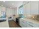 Modern kitchen with custom cabinetry, stainless steel appliances, and stylish backsplash at 870 N Shore Dr, Anna Maria, FL 34216
