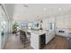 Open-concept kitchen featuring a center island with seating, modern appliances, and seamless flow to the living area at 870 N Shore Dr, Anna Maria, FL 34216