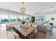 Living room and dining area featuring a large table, comfortable seating, and panoramic views at 870 N Shore Dr, Anna Maria, FL 34216
