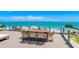 Relaxing outdoor dining area on a deck with panoramic ocean views, perfect for enjoying meals with a view at 870 N Shore Dr, Anna Maria, FL 34216