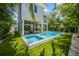 An inviting pool with stepping stones and nearby outdoor living under the elevated home at 870 N Shore Dr, Anna Maria, FL 34216