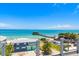 Breathtaking waterfront view featuring a pier, clear turquoise water, and a charming coastal town at 870 N Shore Dr, Anna Maria, FL 34216