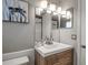 Bright bathroom features a modern vanity, a framed mirror, and a turtle art piece enhancing its appeal at 927 Lemon Bay Dr, Venice, FL 34293