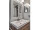 Bright bathroom features a framed mirror and a wood vanity, enhancing its appeal at 927 Lemon Bay Dr, Venice, FL 34293