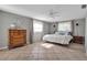 Bright bedroom with tile floors, neutral paint, ceiling fan and multiple windows at 927 Lemon Bay Dr, Venice, FL 34293