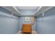 Walk-in closet with blue walls, shelves, and tile floors providing ample storage space at 927 Lemon Bay Dr, Venice, FL 34293