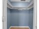 Walk-in closet with blue walls, shelves, and tile floors providing ample storage space at 927 Lemon Bay Dr, Venice, FL 34293