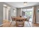 Cozy dining area with tile flooring, wicker chairs, and access to screened patio at 927 Lemon Bay Dr, Venice, FL 34293