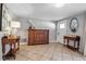 Spacious entryway featuring tile flooring, vintage furniture, and a white front door at 927 Lemon Bay Dr, Venice, FL 34293