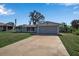 Charming single-story home with a two-car garage, a well-kept lawn, and mature landscaping at 927 Lemon Bay Dr, Venice, FL 34293