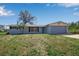 Charming single-story home with a two-car garage, a well-kept lawn, and mature landscaping at 927 Lemon Bay Dr, Venice, FL 34293