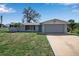 Charming single-story home with a two-car garage, a well-kept lawn, and mature landscaping at 927 Lemon Bay Dr, Venice, FL 34293