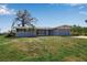 Charming single-story home with a two-car garage, a well-kept lawn, and mature landscaping at 927 Lemon Bay Dr, Venice, FL 34293