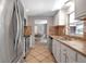 Open kitchen view with stainless steel appliances and an adjacent dining area at 927 Lemon Bay Dr, Venice, FL 34293