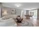 Open-plan living room, white sofa, wicker dining set, and natural lighting at 927 Lemon Bay Dr, Venice, FL 34293