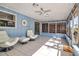 Bright sunroom featuring tile floors, ceiling fan, and comfortable swivel chairs at 927 Lemon Bay Dr, Venice, FL 34293