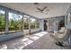 Inviting sunroom with tile flooring, fan and lots of natural light at 927 Lemon Bay Dr, Venice, FL 34293