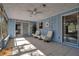 Beautiful light blue sunroom featuring sliding glass doors and swivel chairs at 927 Lemon Bay Dr, Venice, FL 34293